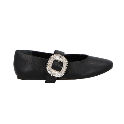 Black flat shoe with a decorative buckle on a white background