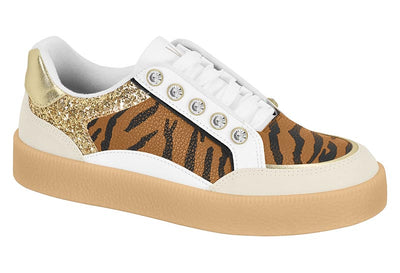 Sneaker with tiger stripe pattern and gold accents on a white background