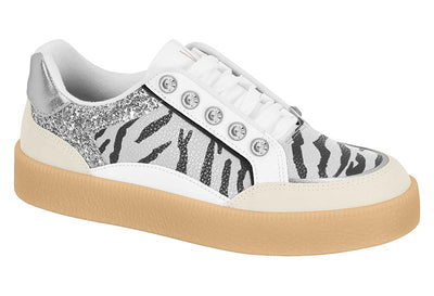 Sneaker with zebra pattern and glittery accents on a white background
