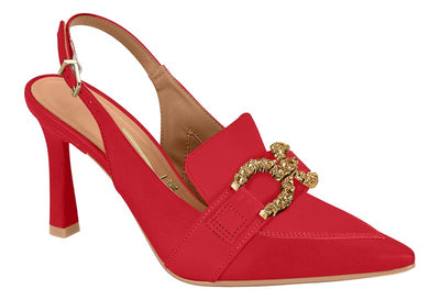 Red high-heeled shoe with a gold buckle on a white background