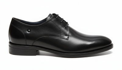 Black leather dress shoe on a white background