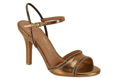 Gold high-heeled sandal on a white background