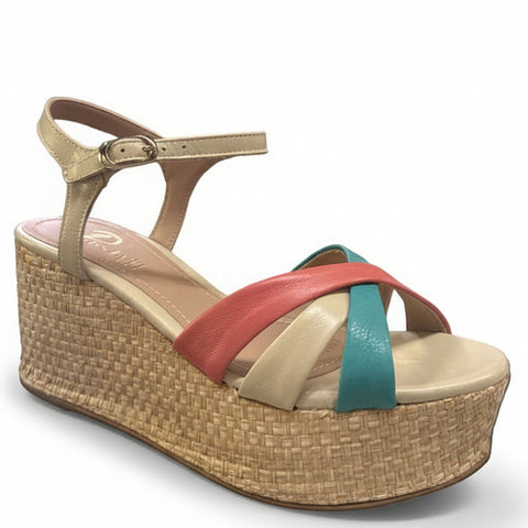Woven sandal with a green strap on a surface with boxes in the background