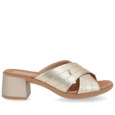 Gold sandal with a block heel on a white background