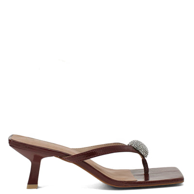 Brown high-heeled sandal with a decorative strap on a white background
