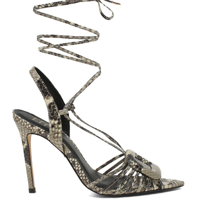 High-heeled sandal with snake print straps on a white background