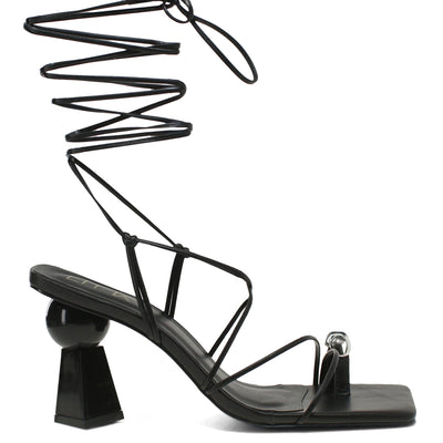 Black sandal with unique design on a white background