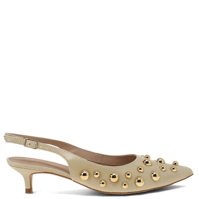 Beige high-heeled shoe with gold studs on a white background